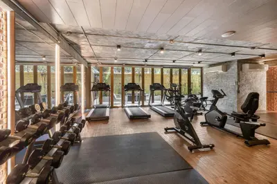 a gym with treadmills and elliptical machines at Alcove 53 in Bangkok