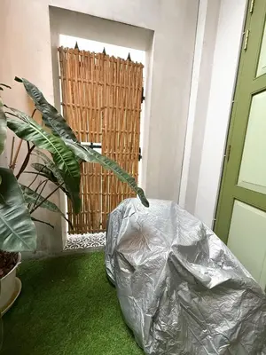 a room with a green floor and a wooden gate at Baan Lek Tee 6 - 9Chinatown near Yaowarat and MRT in Bangkok