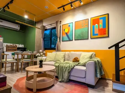 a living room with a couch and a table at Cozy Canal House 1 min to MRT & Street Foods in Bangkok