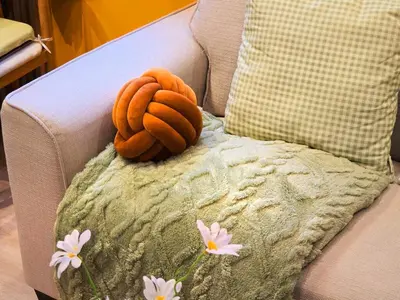 a stuffed animal is sitting on a couch with flowers at Cozy Canal House 1 min to MRT & Street Foods in Bangkok