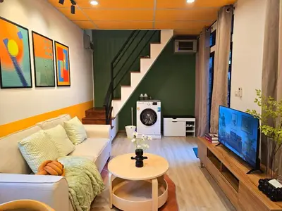 a living room with a couch and a tv at Cozy Canal House 1 min to MRT & Street Foods in Bangkok