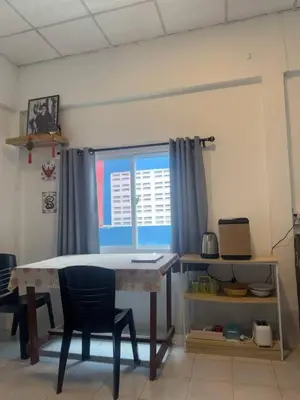 a room with a table and chairs and a window at Sitjaroonsak Muaythai Gym in Bangkok