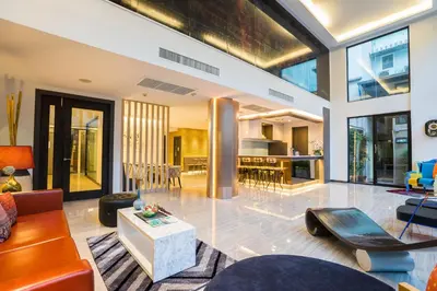a living room with a couch and a table at Aim House Bangkok No Parking in Bangkok