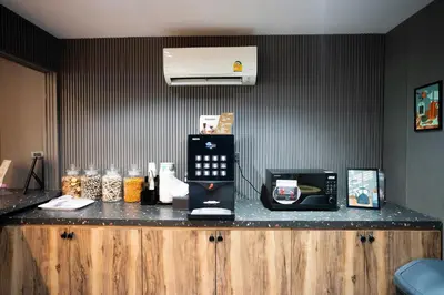 a kitchen with a counter with a toaster and a microwave at Infinite Hotel-Ratchada in Bangkok