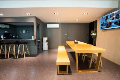 a dining room with a table and a bench at Infinite Hotel-Ratchada in Bangkok