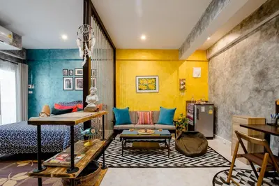 a living room with a bed and a couch at Double Studio with Balcony & Private Bath by Smile Loft in Bangkok