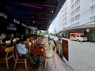 a group of people sitting at tables in a restaurant at XX The Hidden Khaosan - เดอะฮิดเด้นถนนข้าวสาร รามบุตรี in Bangkok