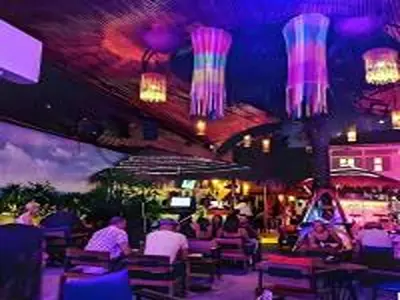 a restaurant with people sitting at tables and lights at XX The Hidden Khaosan - เดอะฮิดเด้นถนนข้าวสาร รามบุตรี in Bangkok