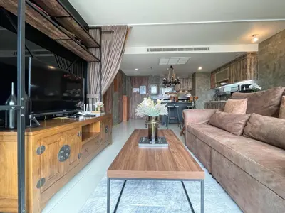 a living room with a couch and a coffee table at Loft style Large 69 SQMFast WiFi BTS Chong Nonsi in Bangkok