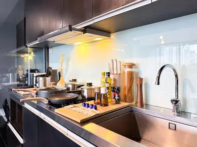 a kitchen with a sink and a counter top at Expansive Luxury 2BR - Ultra Fast Wifi - Phrom Phong in Bangkok