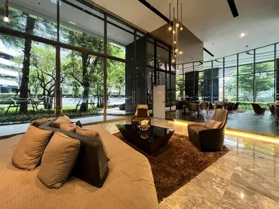a large living room with a large couch and chairs at Cozy Park-view 1BR - Ultra Fast Wifi - BTS Bangna in Bangkok