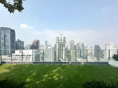 a view of a city skyline with a green field at Luxurious Downtown 1BR - Ultra Fast WiFi - BTS Asoke in Bangkok