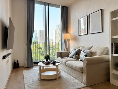 a living room with a couch and a table at Luxurious Downtown 1BR - Ultra Fast WiFi - BTS Asoke in Bangkok