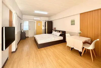 a bedroom with a bed and a table and a tv at Budget 1b1b Heart of Ramkamheng in Sathani Khlong Tan