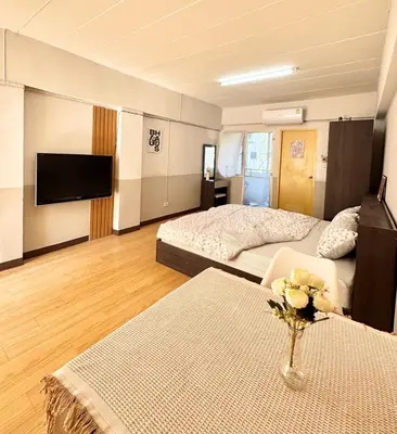 a large room with two beds and a tv at Budget 1b1b Heart of Ramkamheng in Sathani Khlong Tan