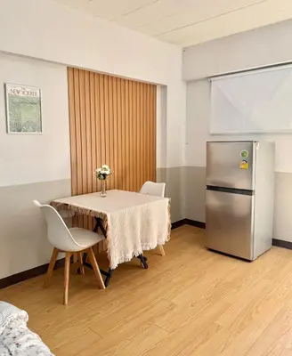 a dining room with a table and a refrigerator at Budget 1b1b Heart of Ramkamheng in Sathani Khlong Tan