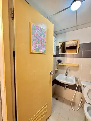 a bathroom with a yellow door and a sink at Budget 1b1b Heart of Ramkamheng in Sathani Khlong Tan