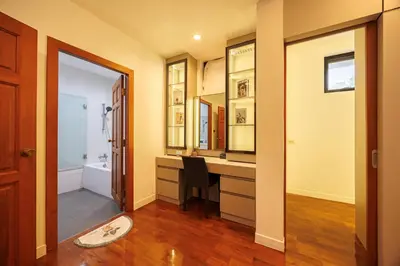 a bathroom with a desk and a sink and a mirror at Bangkok Manor One\u66fc\u8c37\u58f9\u53f7\u5e84\u56ed in Bangkok