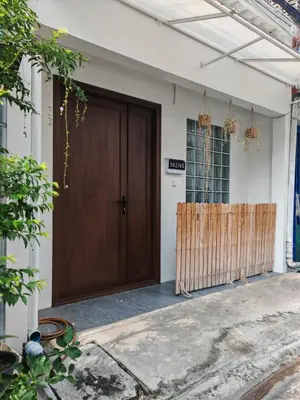 a wooden door of a house with a fence at Super cozy new townhome in central of Bangkok 4 PAX in Ban Chek