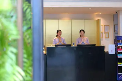 two women sitting at a desk with their laptops at Hotel Once Bangkok in Bangkok