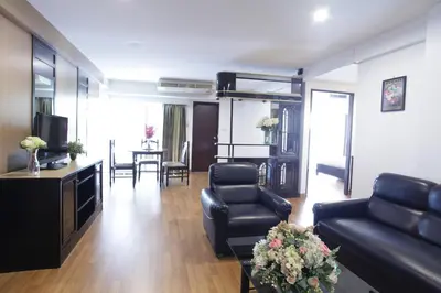 a living room with a couch and a table at Nanatai Suites in Bangkok