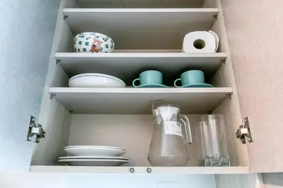 a cupboard filled with dishes and a blender at TC Contel at Bts Samrong in Ban Khlong Samrong
