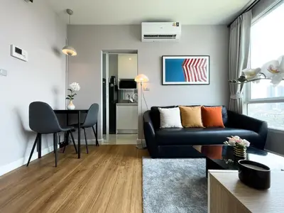 a living room with a couch and a table at Prime Sukhumvit Stay 1 BR - Fast WiFi - BTS Udomsuk in Bangkok