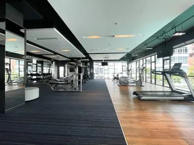 a gym with treadmills and exercise equipment in a building at Prime Sukhumvit Stay 1 BR - Fast WiFi - BTS Udomsuk in Bangkok