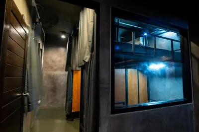 a hallway with a door and a window in a room at Another High Away Hostel - Bangkok in Nonthaburi