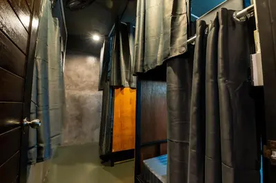 a room with a door and curtains in a room at Another High Away Hostel - Bangkok in Nonthaburi