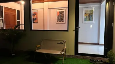 a chair sitting in front of a door at Thonglor 25 Noble House in Bangkok