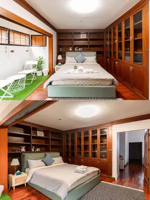 a bedroom with two beds and wooden cabinets at Thonglor 25 Noble House in Bangkok