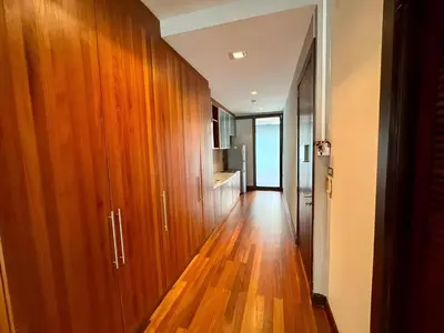 a hallway with wooden cabinets and a hard wood floor at XX Wish Inn Silom Decho Road - วิช อินน์ สีลม เดโช in Bangkok