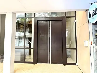 a revolving door in a building with glass at XX Wish Inn Silom Decho Road - วิช อินน์ สีลม เดโช in Bangkok