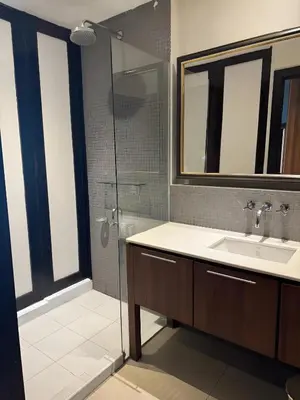 a bathroom with a sink and a glass shower at XX Wish Inn Silom Decho Road - วิช อินน์ สีลม เดโช in Bangkok