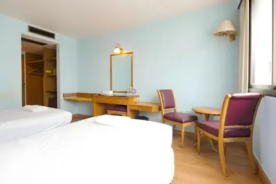 a bedroom with a table and chairs and a mirror at XX Wish Inn Chidlom Bangkok - วิชอินน์ ชิดลม กรุงเทพ in Pratunam