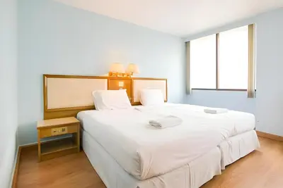 a bedroom with a large white bed and a window at XX Wish Inn Chidlom V - วิชช์อินน์ ชิดลม in Pratunam