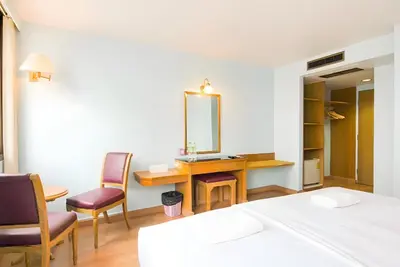 a bedroom with a desk and chairs and a mirror at XX Wish Inn Chidlom V - วิชช์อินน์ ชิดลม in Pratunam
