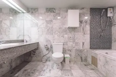 a bathroom with a toilet and a sink and a tub at 2 bedroom state tower Sathorn in Bangkok