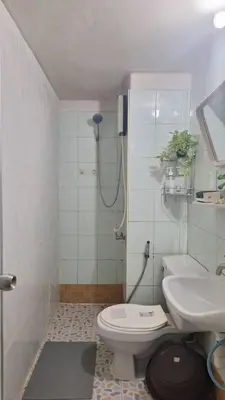 a bathroom with a shower and a toilet and a sink at Popular Muang Thong C5 in Thung Si Kan