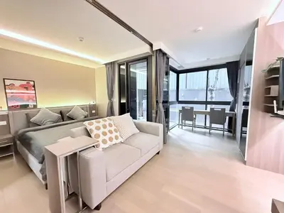 a living room with a couch and a table at BTS Thong Lor Downtown Low-rise Large Studio #Private Courtyard Super Large Pool in Bangkok