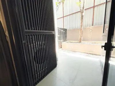 an open door to a building with a gate at BTS Thong Lor Downtown Low-rise Large Studio #Private Courtyard Super Large Pool in Bangkok