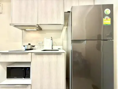 a kitchen with a stainless steel refrigerator and a microwave at Thonglor Central Low rise Condominium in Bangkok