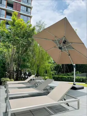 a row of picnic tables with an umbrella at Thonglor Central Low rise Condominium in Bangkok