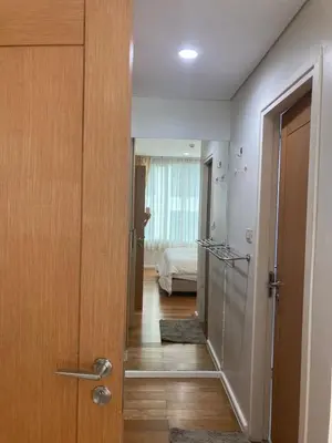 a hallway with a door leading to a bedroom at 'City Retreat' Asok Sukhumvit 23 Room 53 sqm in Bangkok