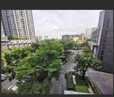 a view of a city street with trees and buildings at Octopus Suite on HighRise, Skytrain, Fast Wifi and AC in Amphoe Phra Khanong