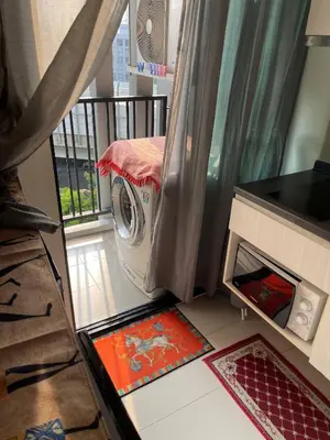 a washing machine in a room with a balcony at Immaculate Quite Resort Home, brand new ACsWiFi in Amphoe Phra Khanong