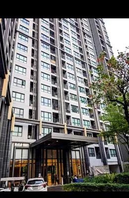 a large building with a car parked in front of it at Immaculate Quite Resort Home, brand new ACsWiFi in Amphoe Phra Khanong