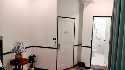 a white room with a door and a mirror at xxThe Character Yaowarat Mrt Wat Mangkon Station - เดอะคาแรคเตอร์ เยาวราช สถานีวัดมังกร in Bangkok