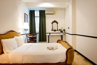 a hotel room with a bed with a towel on it at xxThe Character Yaowarat Mrt Wat Mangkon Station - เดอะคาแรคเตอร์ เยาวราช สถานีวัดมังกร in Bangkok